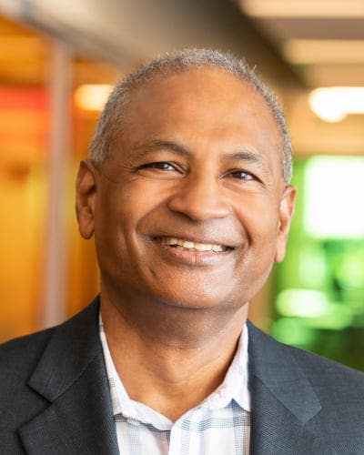 Man in blazer smiling at camera