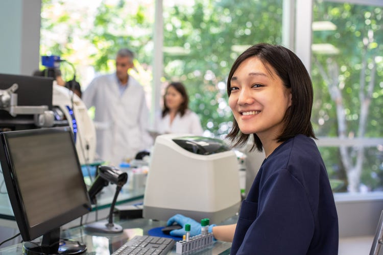 One male and two female scientists in a lab meeting