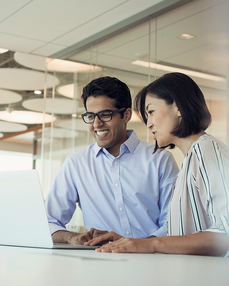 Two people working at computer